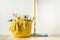 Brushes, bottles with cleaning liquids, sponges, rag and yellow rubber gloves on white background. Cleaning supplies in the yellow