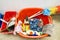 Brushes sponges and bottles in a red bucket for cleaning and washing appartment