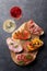 Brushetta or traditional spanish tapas. Appetizers italian antipasti snacks set on wooden board with rose and white wine. Top view