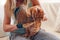 Brushing cat with glove to remove pets hair. Woman taking care of animal combing it with hand rubber glove at home