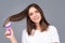 Brushing Hair. Portrait young woman brushing straight natural hair with comb. Girl combing healthy hair with hairbrush