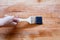 Brushing to apply varnish paint on a wooden surface