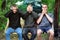 Brusilov, Ukraine - July 13, 2017: Three guys in the forest are sitting on a swing. Funny guys. Abstract photo