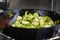 Brussel sprouts cooking in cast iron skillet