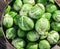 Brussel sprouts in the copper pan on the old wooden table