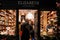 Brussels, Belgium - 10.12.2019 - A Belgium chocolate store`s window. Customers ordering in the store. Cosy window with Christmas d