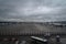 Brussels, Belgium - 2019-11-27: Airliners parked at the terminal in Brussels Airport, on a dark, rainy day