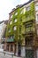 Brussels, Belgium - April 17 :  A building with plants and creepers growing out of the walls in Brussels, Belgium, Europe on april