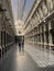 Brussels, Belgium, April 25, 2020 - two people inside the luxury glazed shopping arcade Les Galeries Royales Saint-Hubert during