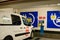 Brussels, Belgium, August 2019. In a public car park, charging station for electric vehicles. A white van was connected to the