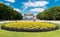 Brussels - Belgium - The cinquantenaire city park with a fountain, colorful flowers and the symbolic arcades in the background