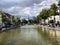 Brussels, Belgium - June 15, 2019: Jules Anspach fountain and Quai aux Briques in a bright cloudy day of summer