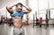 Brutal athletic man taking shirt off on the gym