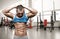 Brutal athletic man taking shirt off on the gym