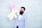 Brutal bearded hipster in formal wear. businessman hold bear toy and balloon. tuxedo man ready for romantic date