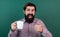 brutal bearded man hold cup of tea and show thumb up. morning energy. just inspired. back to school. formal education