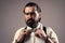 brutal bearded man with moustache wear suspenders and bow tie, retro fashion look