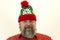 A brutal, bearded, stern man in a red shirt and Santa`s hat. A variety of emotions. Cruelty and masculinity.