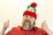A brutal, bearded, stern man in a red shirt and Santa`s hat. A variety of emotions. Cruelty and masculinity.