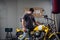 A brutal biker buys a yellow powerful motorcycle. He checks it in the garage.