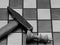 Brutal Checkmate: Hammer Next To A Defeated King On A Chess Board, Monochrome