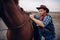 Brutal cowboy climbs on horseback on texas ranch
