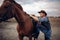 Brutal cowboy climbs on horseback on texas ranch