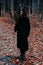 Brutal depressive Gothic stylish long haired man in autumn forest