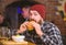 Brutal hipster bearded man sit at bar counter. High calorie food. Cheat meal. Delicious burger concept. Enjoy taste of