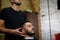 A brutal-looking Barber cuts the hair of an Indian guy. cinematic image