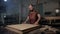 Brutal master carpenter prepares wooden blanks for work in workshop