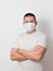 A brutal, middle-aged man in a medical mask on his face looks at the camera on a white background. stop the coronavirus