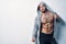 Brutal naked muscular man dressed in a grey hoodie