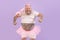 Brutal obese man in fairy costume holds magic stick in teeth on purple background