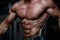 Brutal strong bodybuilder athletic men pumping up muscles with d