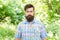 Brutal style trends. Bearded man with brutal look on natural landscape. Caucasian guy with long brutal beard and