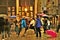 Bruxelles, Grand Place. A couple of Asian tourists place their umbrella on the ground in the center of the square and stand still.