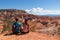 Bryce Canyon - Sitting couple with scenic aerial view from Fairyland hiking trail on massive hoodoo sandstone rock formations