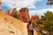 Bryce Canyon - Woman hiking on Peekaboo trail with scenic view of hoodoo sandstone rock formations in Utah, USA