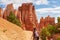 Bryce Canyon - Woman hiking on Peekaboo trail with scenic view of hoodoo sandstone rock formations in Utah, USA