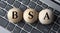 BSA - acronym on wooden balls on laptop keyboard background