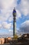 BT Tower rising against blue sky with partially cloudy sky over buildings