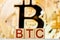 btc concept. wooden blocks with the inscription btc with bitcoin on the background.