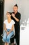 BTS of Celebrity hairstylist Reto Camichel in a salon with a female model