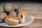 Buah sawo or sapodilla fruit on a white plate