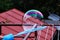 A bubble attaching on bubble blower use as decoration. On the top of bubble is green and purple filter and in the background there