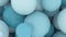 Bubble birth - green, turquoise, blue balloons are born on a white background filling the entire screen, balloons, spheres.