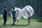Bubble football. Journalist and cameraman interviewing a man standing in bubble