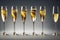 Bubbles of champagne bubbling in glasses on thin glass stems.