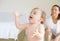 These bubbles are mind-blowing. An adorable baby girl reaching for a bubble with her mother smiling in the background.